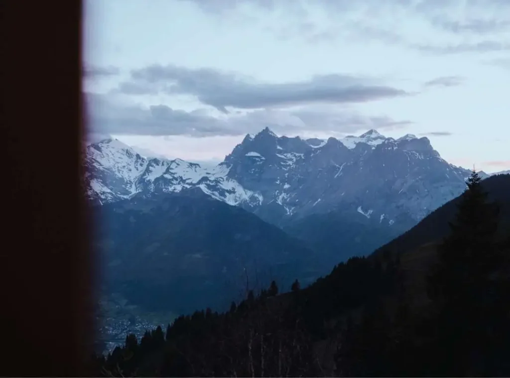 Majestic snow-covered mountain peaks in the Swiss Alps at dusk, symbolizing resilience, leadership, and the freedom of a portfolio career.