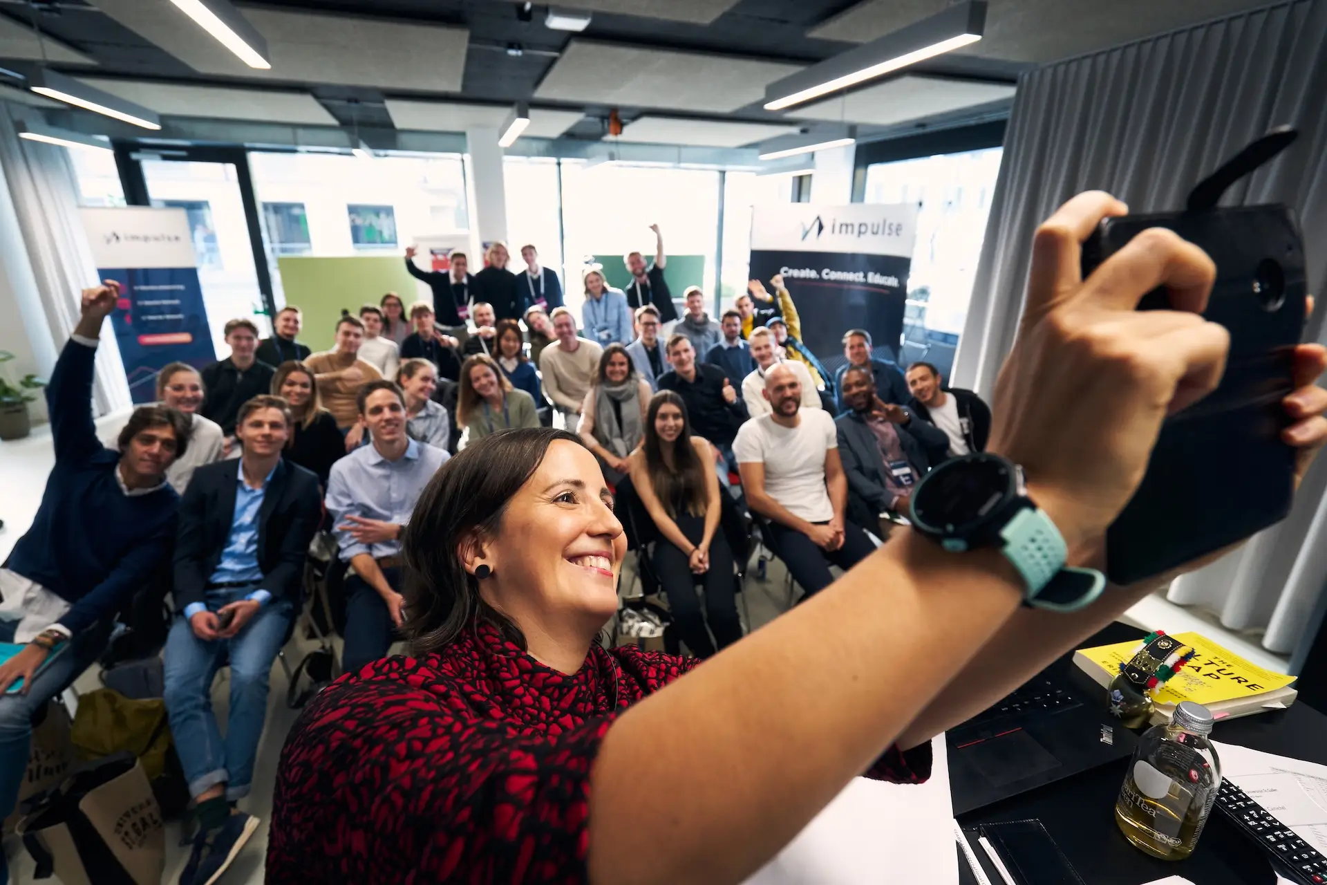 Andreia Fernandes leading an interactive leadership keynote, inspiring a diverse audience in a corporate workshop setting.